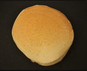 A pancake cooking on a pan