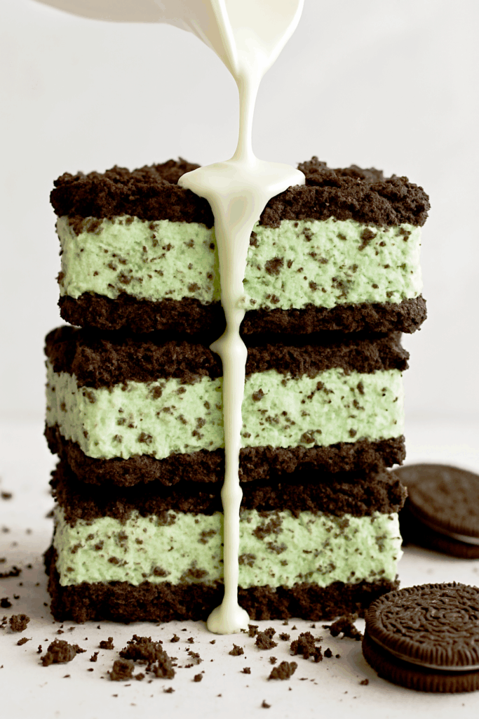 Low-Calorie Mint Oreo cheesecake cookies served with a glass of milk pored on top of it indulgent yet healthy treat packed with protein, perfect post-workout snack.