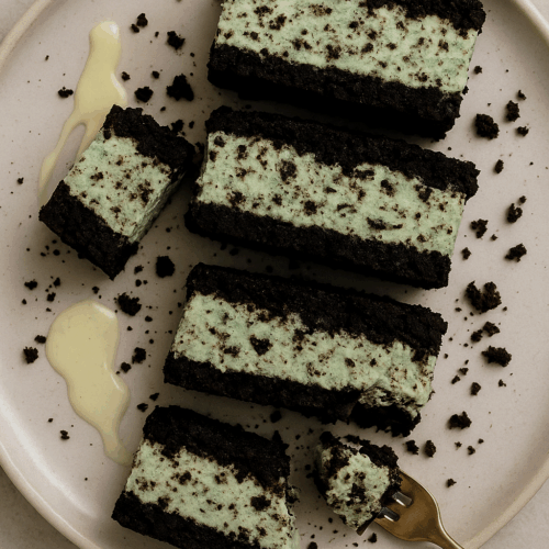 Flat lay of fresh-baked low calorie Mint Oreo cheesecake cookies on cooling rack, soft chewy texture with minty cream, healthy dessert recipe.