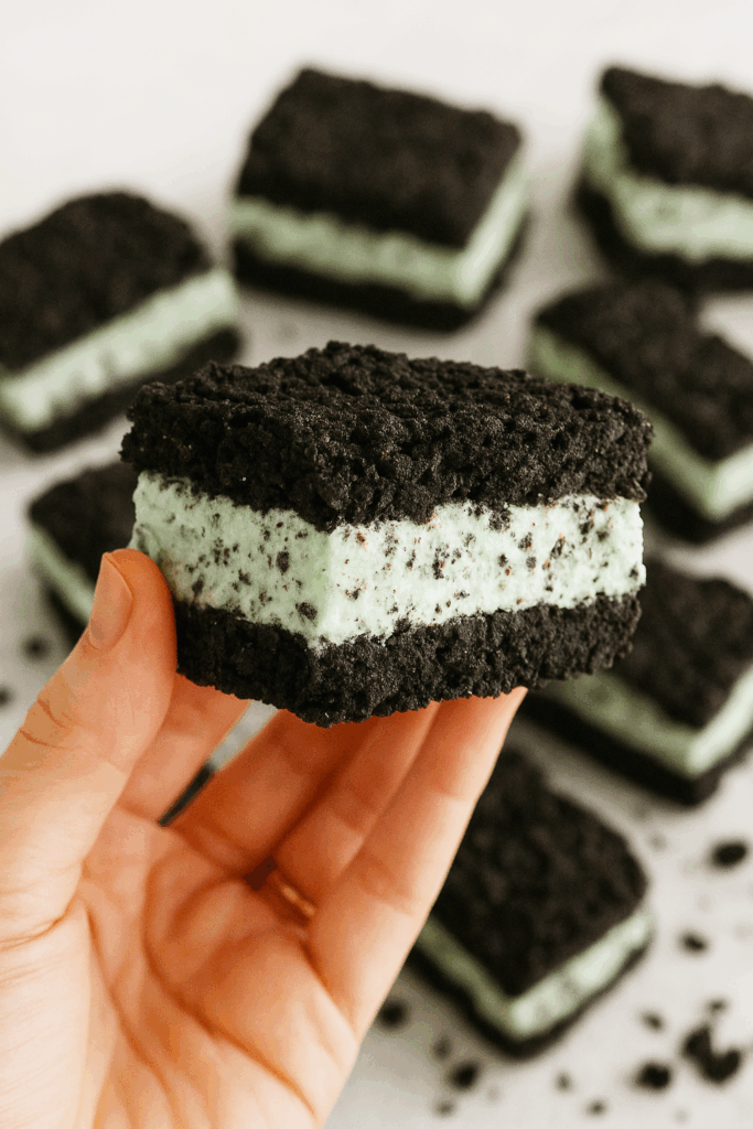 Close-up of low calorie Mint Oreo cookie broken in half, showing creamy mint cheesecake center, easy healthy low calorie dessert idea.