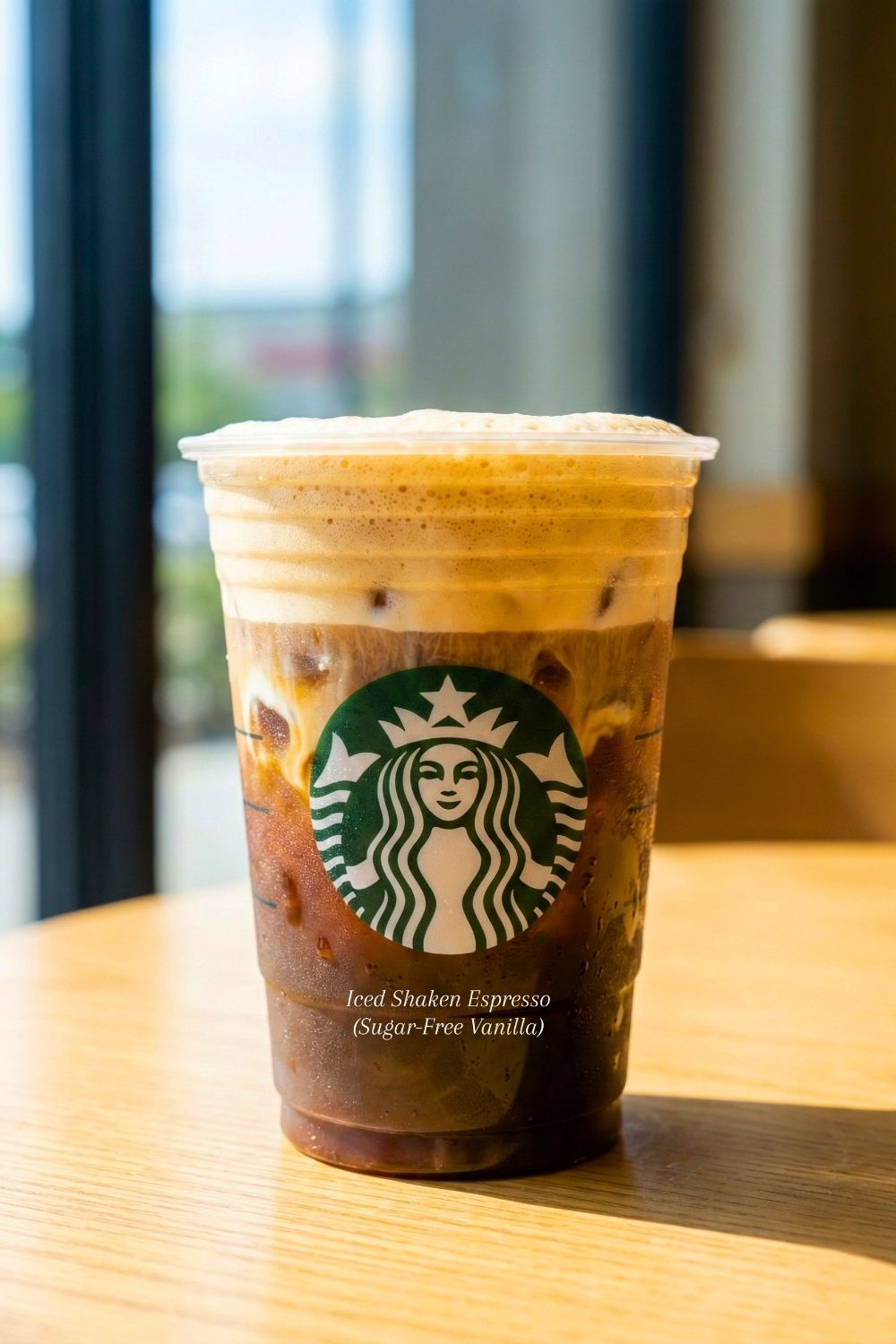 Refreshing iced shaken espresso with sugar-free vanilla syrup and soy milk in a clear cup with condensation.