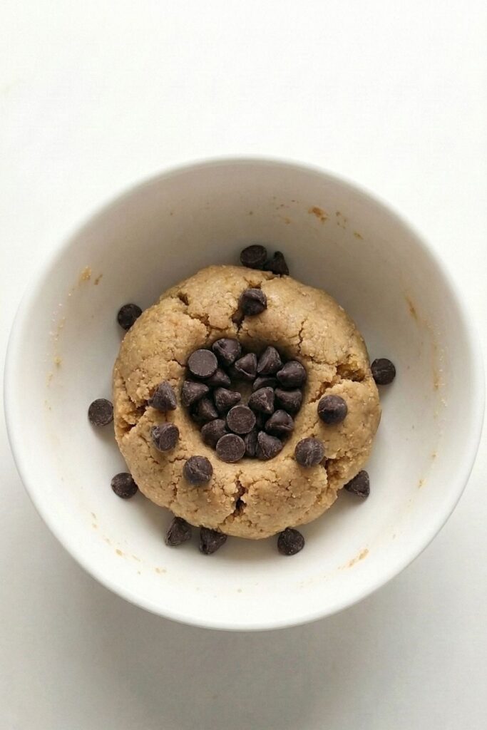 Dark chocolate chips added to the top of the formed protein dough ball.