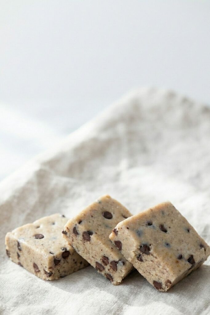 Minimalist overhead shot of protein bars on a white background with negative space for text, perfect for healthy recipe Pinterest pins.